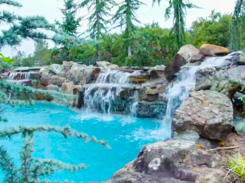 waterfall and swimming pool with boulders