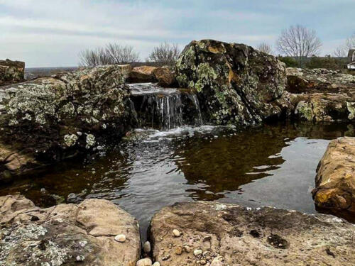 waterfall and pond with mossy boulders