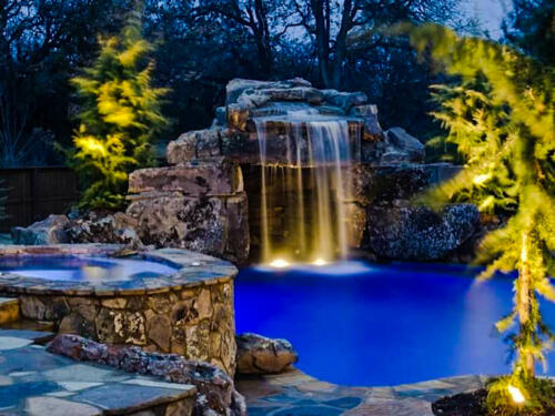 waterfall with lights and boulders