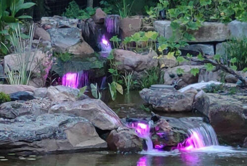 waterfall with lights and boulders